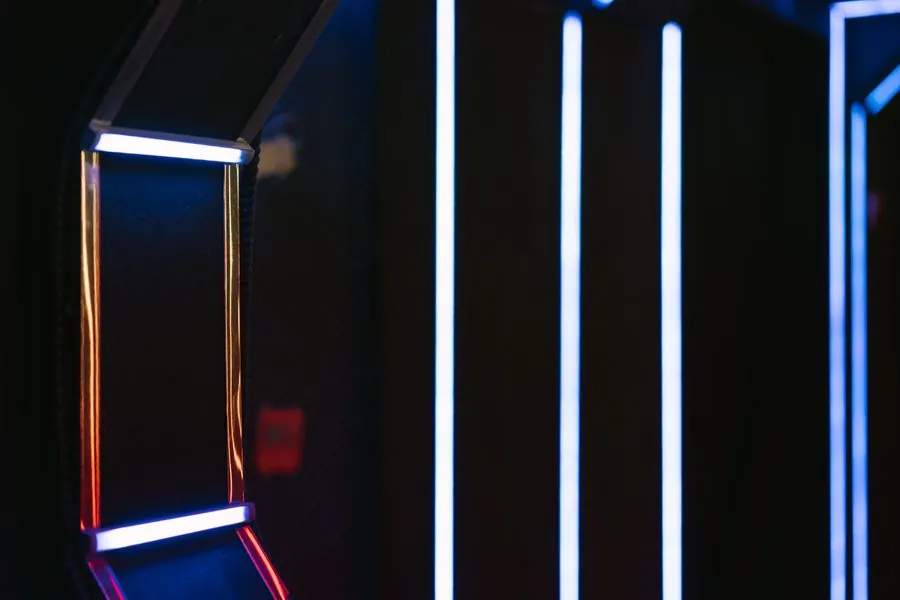 A dark corridor lit by thin lines of light